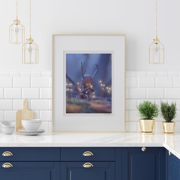 The photo of a Becorn with tiny glowing flowers in a very thin gold frame on a white marble countertop leaning on a white tiled wall. In the lower right corner of the print’s white border is David Bird’s signature. There are three minimalist gold wire hanging lamps around the print, and kitchenware on the counter. The drawers under the counter are dark blue.